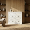 Front Styled view of the Fremont 4 Drawer Chest in white in a modern home