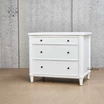 Angled view of Brynmore 3 Drawer Bedside showcasing the three spacious drawers and classic silhouette.