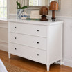 A modern three drawer storage chest in white, showcasing a contemporary design and ample storage.