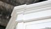 Detailed view of the crown moulding, adding a refined touch to the cabinet’s design.