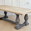 Angled side view of the Parkhouse Double Pedestal Dining Table showcasing its distressed grey base and oak top.