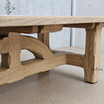 Zoomed-in view of the unique 'bridge-style' legs, a hallmark of the Trailbridge Table’s design.