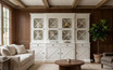 Styled white painted display cabinet with glass doors in a warm minimalist living room with timber panelling