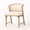 Three quarter front profile of the Windsor Dining Chair with curved timber backrest and tailored premium textured weave upholstered seat, highlighting premium craftsmanship and modern luxury dining design