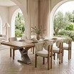 Neutral textured upholstered dining chairs showcased with the Quinn Extendable Dining Table with Metal base by Thomas and Hurley.