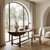 Churchill Barley Twist Oval Drop Leaf Extending Table by Thomas and Hurley styled with Stratford Dining Chairs beneath architectural arched windows.