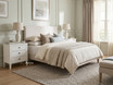 Pair of Lando 3 Drawer bedside tables in white styled with ceramic lamps in a modern Hamptons bedroom, creating a timeless and functional bedroom setting.