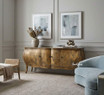 A front angled styled view of the Featherington Commode highlighting sculptural form,  hand-finished patina, and cabriole style legs.
