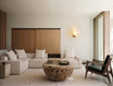 Warm minimalist living space anchored by a natural wood coffee table