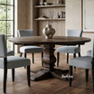 Designer dining chairs in Hampton Blue creating a warm minimalist interior with natural textures styled with a round oak parquetry table