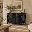 Designer black chest of drawers styled beneath artwork in a refined living space