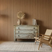 Haslemere 3 Drawer Chest providing elegant vintage storage next to a linen armchair.