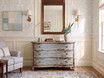 Weathered blue three drawer bombe chest styled in a sophisticated neutral living room