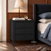 Black bedside table with traditional detailing and a refined silhouette