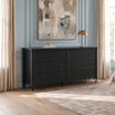 Statement black dresser styled beneath framed artwork on a blue panelled wall