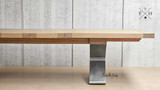 Quinn's contemporary table, with a robust metal base, ideal for versatile dining room aesthetics.