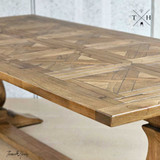 The Strand Table’s surface under natural light, accentuating the rich wood tones