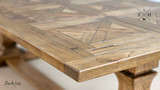 Angled view along the surface, emphasizing the table’s spacious design and beautiful parquetry