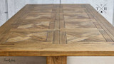 View of the table’s end at its full 250cm length, displaying the parquetry pattern