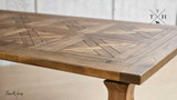 Close-up of the table’s edge, revealing the precision finish and quality of the woodwork