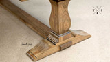Detailed view of the corner pedestal leg design, highlighting the table’s elegant structure