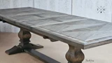 Angled detail of the table top, focusing on the stunning handcrafted parquetry inlay and pedestal table base
