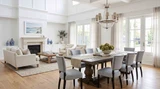 Oak parquetry dining table in bright Hamptons or luxury coastal setting with a large chandelier.