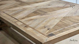 Close-up of the dining table’s edge finish and parquetry detail