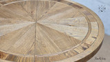 Zoomed-in view focusing on the intricate parquetry surface of the table top