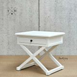 Side angle focusing on the table’s x-base, revealing the attention to detail in its finish