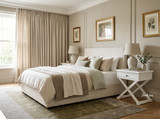 Pair of Hampstead Cross Leg Bedside Side Tables in white with matching ceramic lamps styled beside a modern upholstered bed in an elegant Hamptons bedroom.