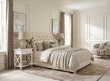 Pair of Hampstead 1 Drawer Bedside Side Tables in white styled on either side of a tufted bed with matching lamps in an elegant Hamptons-inspired bedroom.