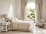 Hampstead 1 Drawer Bedside Side Table in white styled beside a bed with a ceramic lamp and decorative accessories in a light-filled coastal-inspired bedroom.