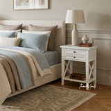 Close-up of the Hampstead 2 Drawer Bedside Side Table in white featuring two drawers, cross-frame side panels, open lower shelf and classic Hamptons design.