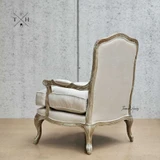 Rear angle showing the intricate back design of the upholstered armchair