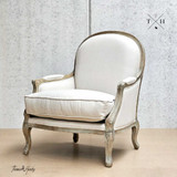 Side angled profile of the chair, showcasing its full linen silhouette