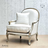Front diagonal view, emphasizing the chair's elegant linen fabric and timeless silhouette