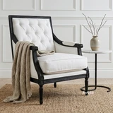 Timeless occasional armchair with button tufted upholstery and black frame