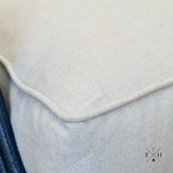 Detailed view of the natural linen upholstery and tufting detail
