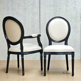 Angled perspective of the Eliza Upholstered Dining Chair and Carver Chair, displaying its proportion and harmony in design