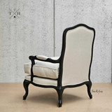 Rear angle showing the intricate back design of the upholstered armchair