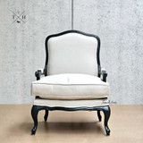 Frontal perspective of Cannes Louis Upholstered Armchair in natural linen with black frame