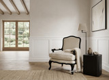 French provincial style curved occasional armchair in linen and black timber legs in a neutral living room with natural light