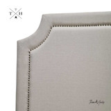 Front corner view of the Parker Natural Linen Headboard, showcasing its silhouette design and natural linen upholstery