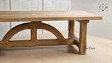 Angled view capturing the detailed edge work of the table’s solid oak construction