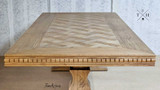 Detailed image of the corner of the Bedford Oak Dining Table, displaying the precision of the parquetry work