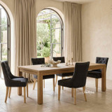 Designer black dining chair with decorative stud trim and natural timber legs by Thomas and Hurley, ideal for Hamptons and contemporary homes.