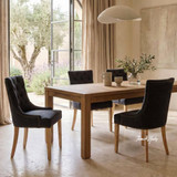 Thomas and Hurley Braddock Dining Chair in Black with Natural Leg styled in a light-filled dining space with elegant contemporary classic décor.