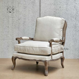 Angled image, focusing on the Hamptons style armchair's elegant design.