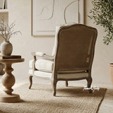 Luxury reading chair featuring a weathered oak frame and woven rattan back by Thomas & Hurley
